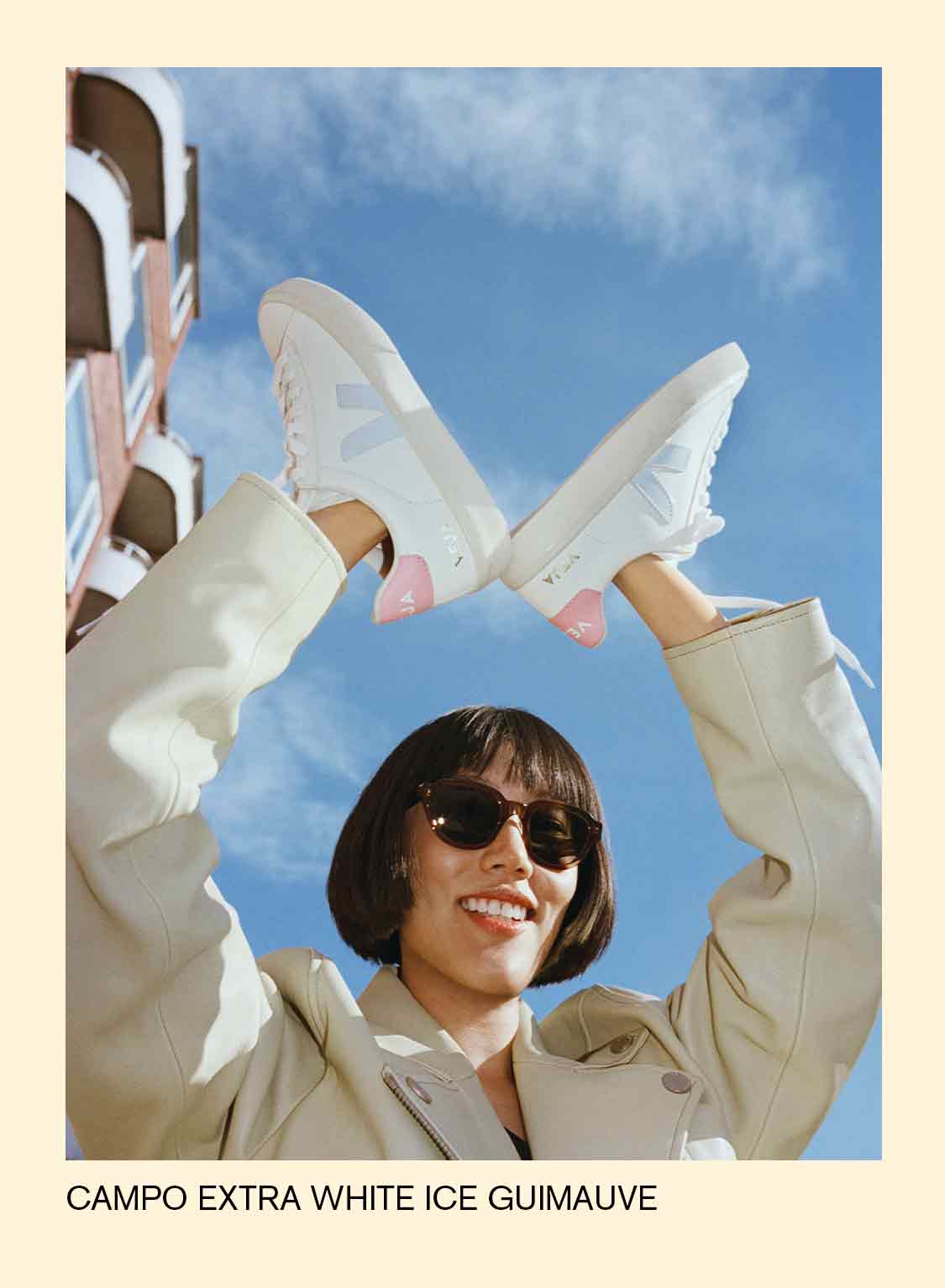 woman wearing in her hands veja campo extra white ice marshmallow sneakers