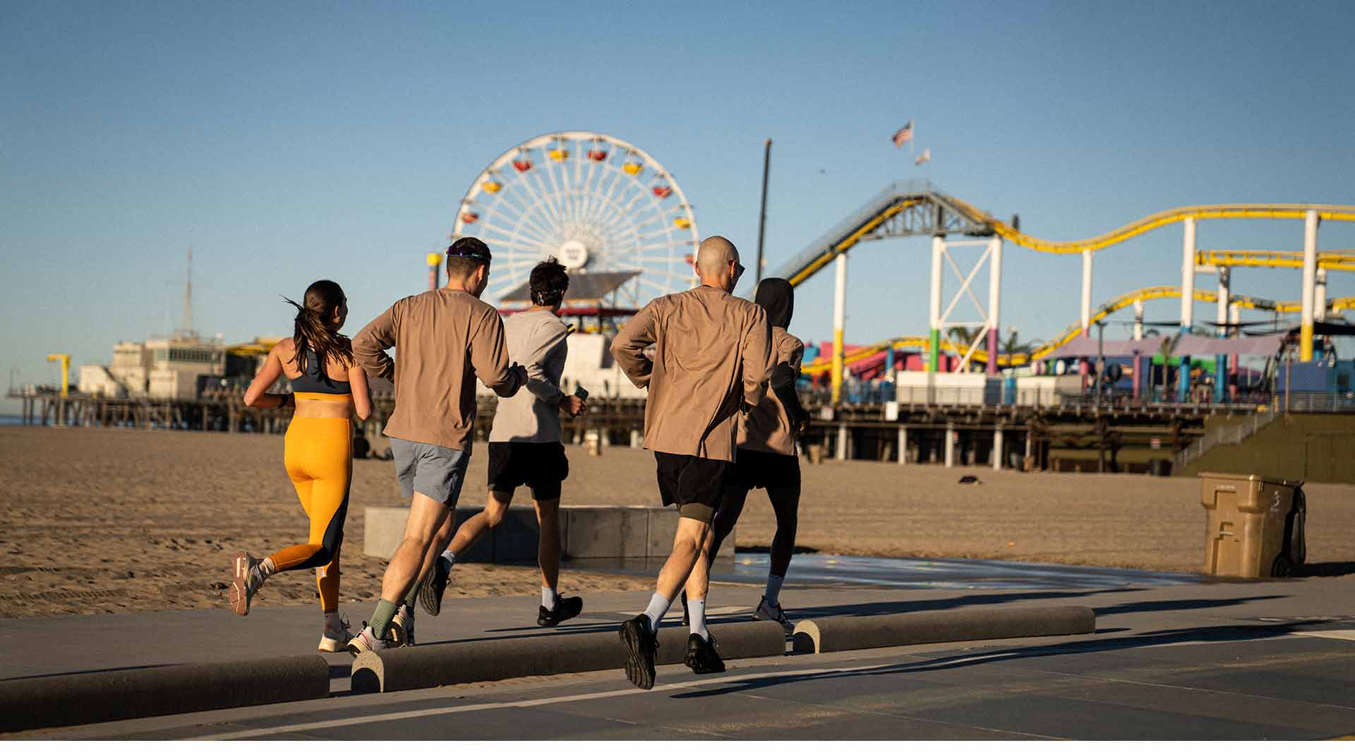 Runners jogging towards the Santa Monica amusement park.